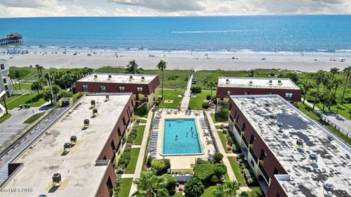 an aerial view of a resort with a swimming pool and the beach at Beautiful Ocean view Townhouse in Cocoa Beach