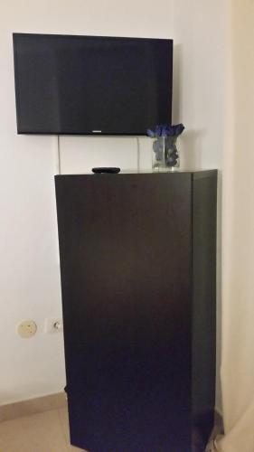 a black refrigerator with a television on top of it at Habitacion con baño privado in Santa Cruz de Tenerife