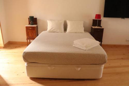 a large bed in a room with at Casa Gil Vicente in Almada
