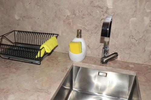 a kitchen counter with a sink and a soap dispenser at Casa Gil Vicente in Almada