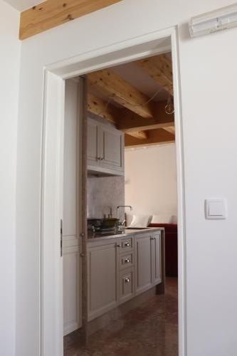 an open door to a kitchen with a counter at Casa Gil Vicente in Almada