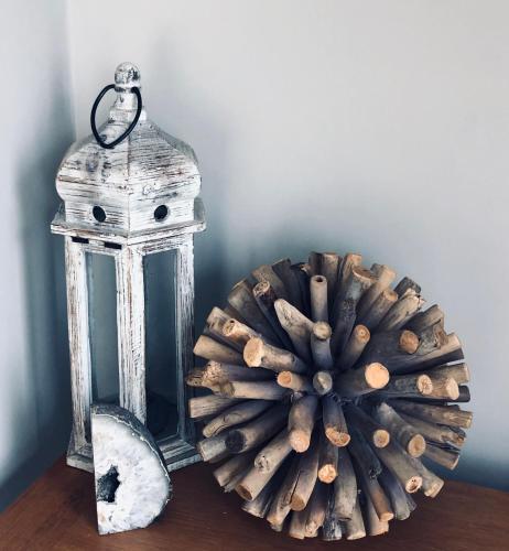 a lantern and a wreath on a table at Woodend Cottage in Dumfries