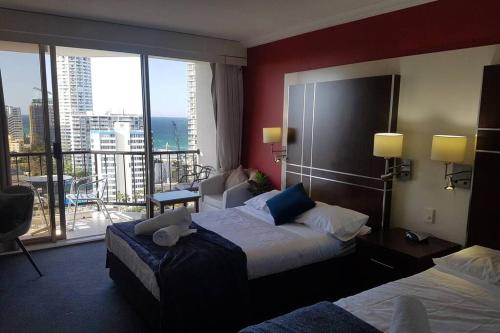 a hotel room with two beds and a balcony at Surfers Ocean View Sleeps 4, Free WIFI, Washing Machine, Large Fridge in Gold Coast