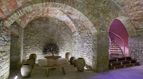 a room with a stone wall and a stone fireplace at Casa Rural Lakoak in Garínoain
