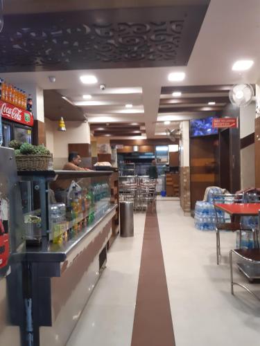a fast food restaurant with a counter and chairs at Sapphire Inn in Bangalore