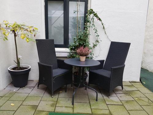 a table and chairs on a patio with a window at B&B Wladimir Studios in Amsterdam