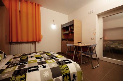 a bedroom with a bed and a table with chairs at Bedrooms B&B in Pescara