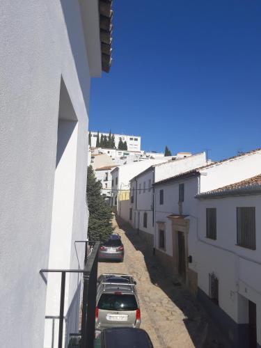 a street with cars parked on the side of a building at Casa Clavero in Ronda