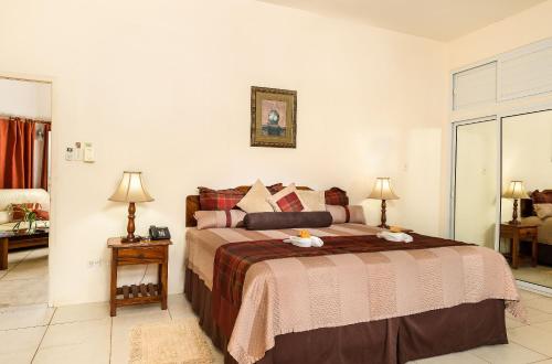 a bedroom with a large bed in a room at Rondel Village in Negril