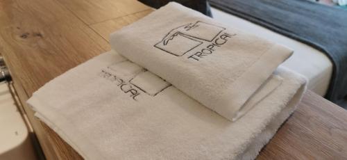 a pair of towels sitting on top of a bed at Playa Grande by Tropical - Adults Only in Gavà