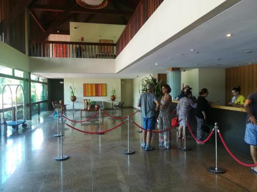 a group of people standing in a lobby with a red rope at Marulhos Resort Porto De Galinhas in Porto De Galinhas