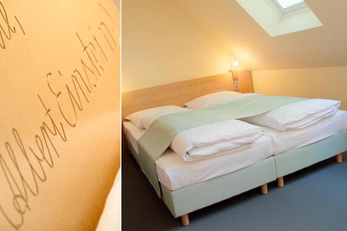 a bedroom with a bed with writing on the wall at Alte Schule Reichenwalde in Reichenwalde