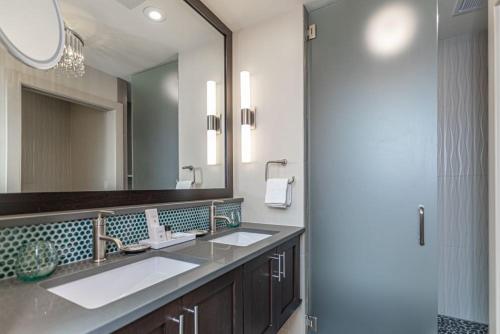 a bathroom with two sinks and a large mirror at Ghost Light Inn in New Hope