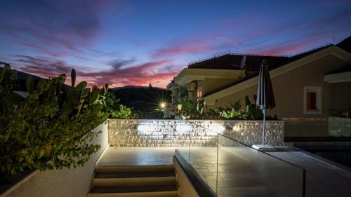 a set of stairs leading up to a house at night at Sun Village Aparthotel in Herceg-Novi