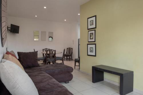 a living room with a couch and a table at Apartamentos Torre II Condominios - Pet Friendly in Mazatlán