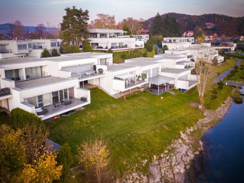 an aerial view of a large white building next to the water at Słoneczny Cypel in Gródek Nad Dunajcem