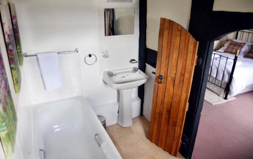 a bathroom with a sink and a toilet and a tub at Rhydspence in Hay-on-Wye