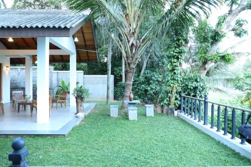 a backyard with a gazebo and grass at Kandy Wellington Apartment in Kandy