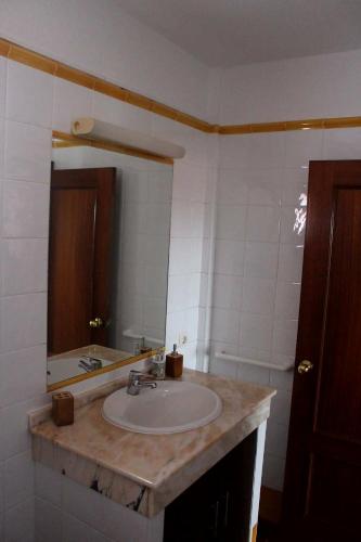 a bathroom with a sink and a mirror at MADESAIK in Breña Baja
