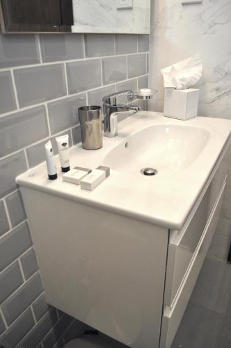 a white bathroom sink with two rolls of toiletries on it at Luxury Suite - Amazing Views & Lovely Garden in Salalah