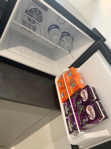 an open refrigerator with food and drinks in it at Rosemary House BRS Airport Accommodation in Bristol