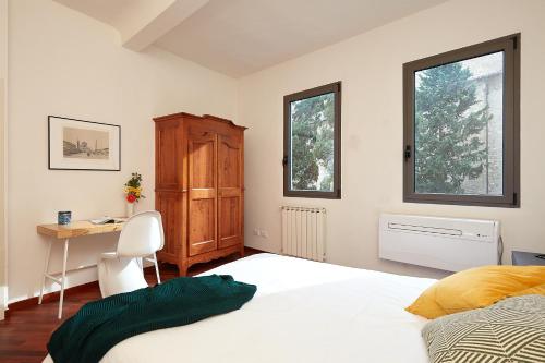 a bedroom with a bed and a desk and window at Casa Cosi - Maria Novella in Florence