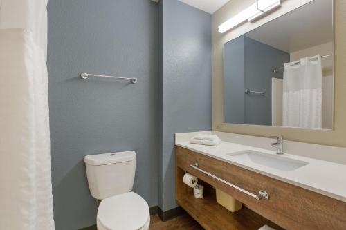 a bathroom with a toilet and a sink with a mirror at Extended Stay America Premier Suites - Union City - Dyer St in Union City