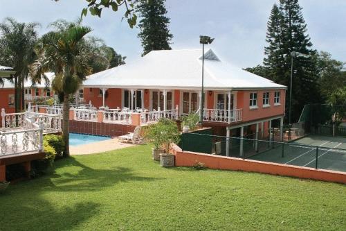 a house with a tennis court in front of it at Sica's Guest House in Durban