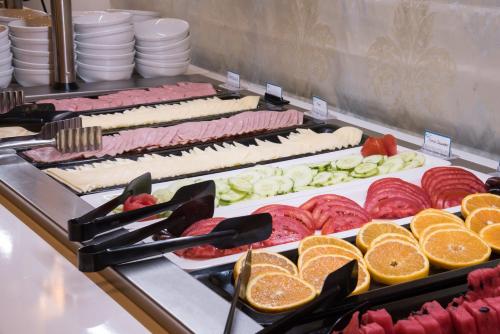 a buffet with many different types of food on display at Windmill Hotel in Argasi