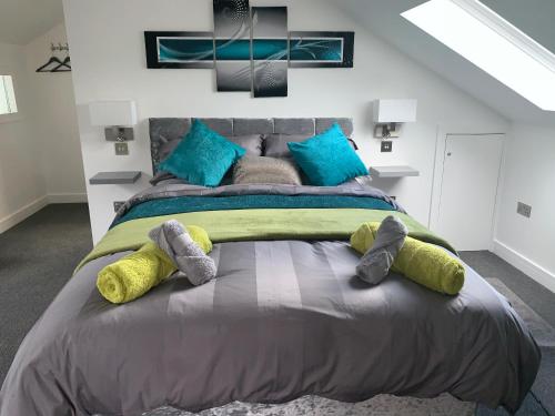 a bedroom with a large bed with stuffed animals on it at Rosemary House BRS Airport Accommodation in Bristol