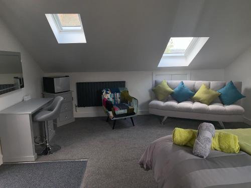a living room with skylights and a bed and a couch at Rosemary House BRS Airport Accommodation in Bristol