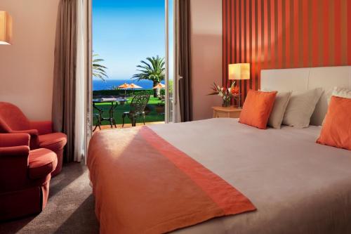 a bedroom with a bed and a view of the ocean at Senhora da Guia Cascais Boutique Hotel in Cascais