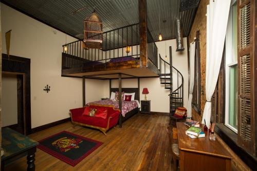 a bedroom with a loft bed and a staircase at Eighteen-Ninety Sleepover in Casey