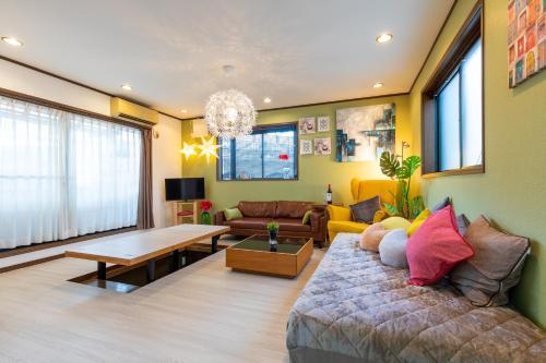 a living room with a couch and a table at Asakusa Skytree View House in Tokyo