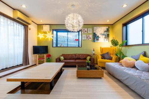 a living room with a couch and a table at Asakusa Skytree View House in Tokyo