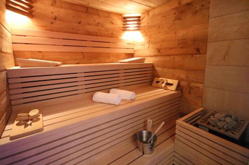 a wooden sauna with two towels in it at Hotel Haus Wiesengrund in Hallenberg