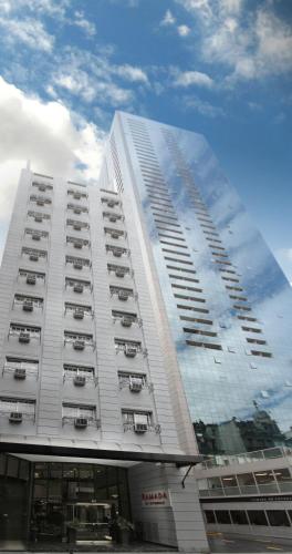 a tall white building with balconies on it at Ramada by Wyndham Buenos Aires Centro in Buenos Aires