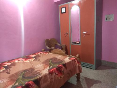 a room with a bed and a mirror at Dreams River view Homestay Coorg in Kushālnagar