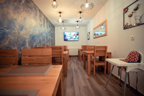 a dining room with wooden tables and chairs at Grand Lakes 2 in Plitvička Jezera
