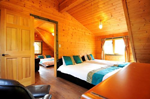 a bedroom with a bed in a wooden cabin at Log sweet Villa YU.CABIN / Vacation STAY 5351 in Inawashiro