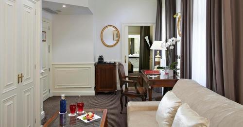 a living room with a couch and a table at Hotel Fenix Gran Meliá - The Leading Hotels of the World in Madrid