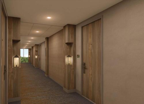 a corridor of a hallway with wooden walls and lights at Wyndham Garden Sacramento Airport Natomas in Sacramento