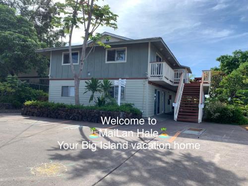 a large house with a driveway in front of it at MaiLan Hale in Kailua-Kona