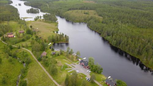 an aerial view of a river with trees and a house at River Lodge in Ludvika