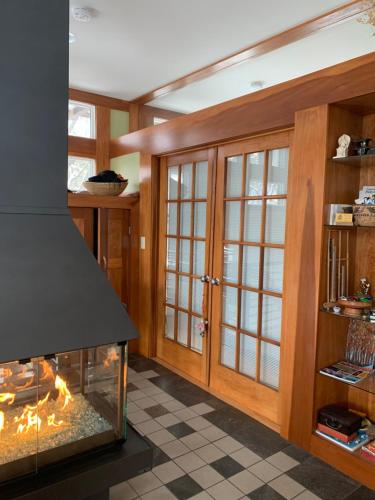a living room with a fireplace and a stove at Baxter House Bed & Breakfast and Apartment in Ann Arbor