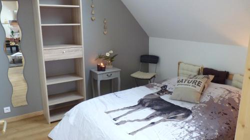 a bedroom with a bed with a dog on it at Forêt de nieppe in Merville