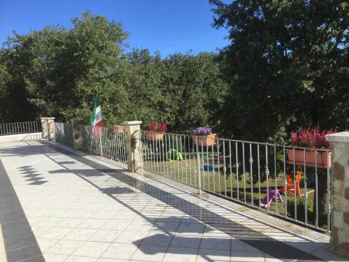 a metal fence with flowers in a yard at Agriturismo Pranu in Sorgono