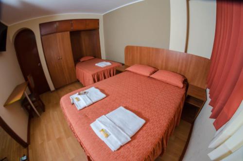 Llit o llits en una habitació de Hotel Arunta