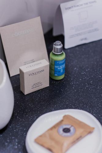 a table with a plate of food and a bottle at Pod Zidom Rooms in Zagreb