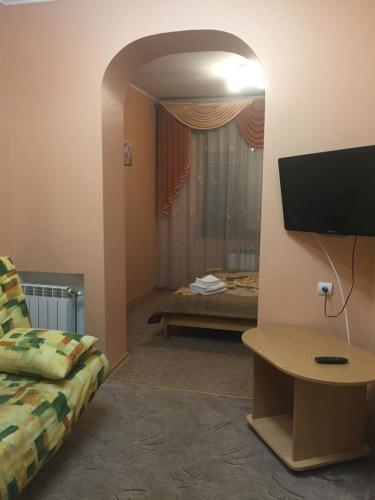 a living room with a couch and a flat screen tv at Мини-отель "Ольга" in Truskavets